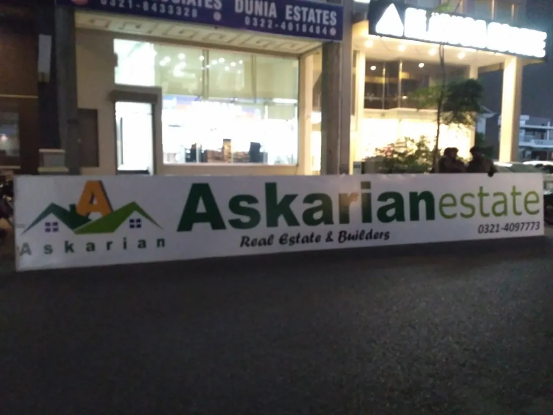 Askarian Estate shop sign lit at night