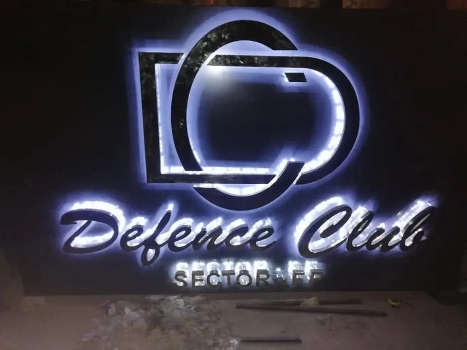 Defence Club Sector FF sign in glowing 3D letters at night